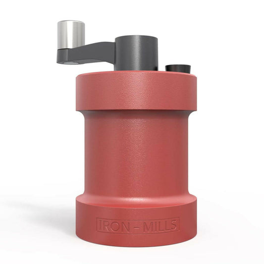 Coral red cast iron salt and pepper mills by Iron-Mills with plain white background.