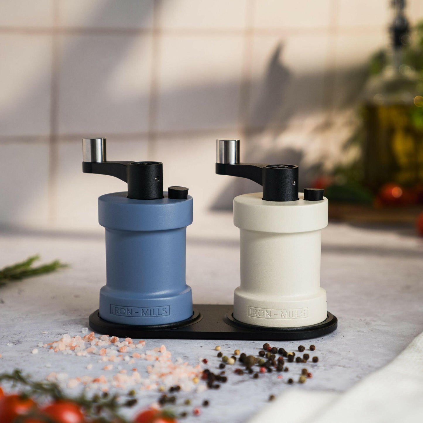 Iron-Mills oyster white and pigeon blue salt and pepper mills resting on a classic mill stand with seasoning accents
